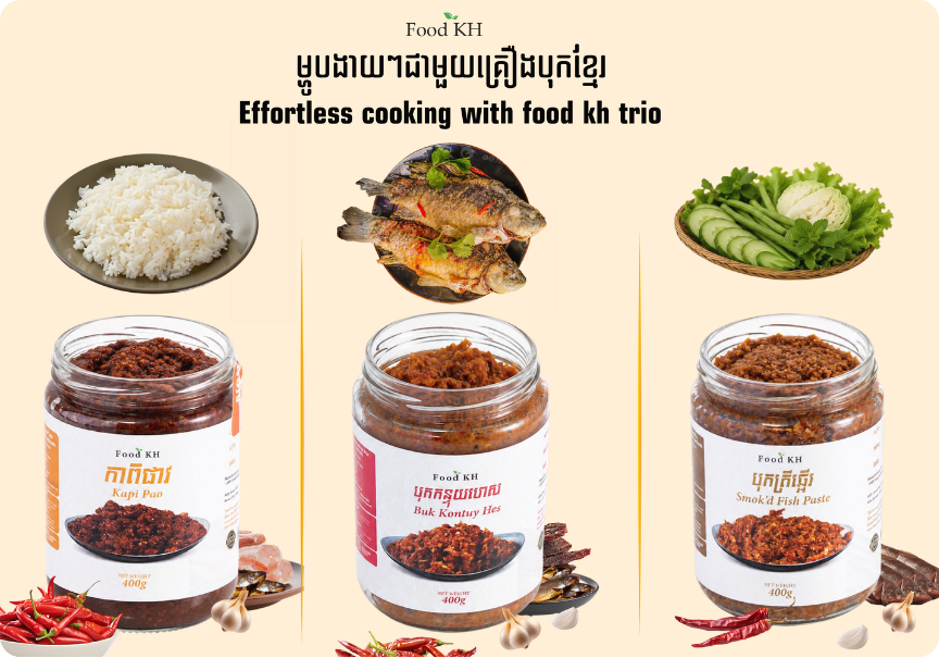 Food KH Trio Bundle display featuring three jars of Cambodian sauces placed below bowls of white rice, fried fish, and a fresh vegetable platter of cucumbers and cabbage.